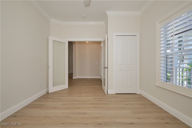 interior space featuring crown molding and light wood-type flooring