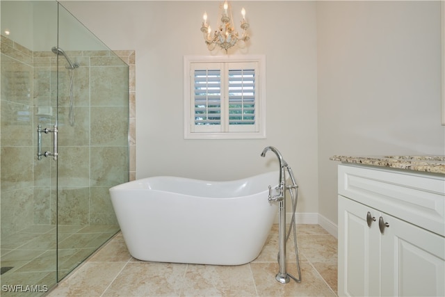 bathroom featuring vanity, a chandelier, and independent shower and bath