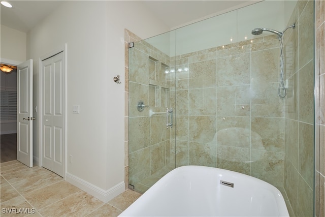 bathroom featuring shower with separate bathtub