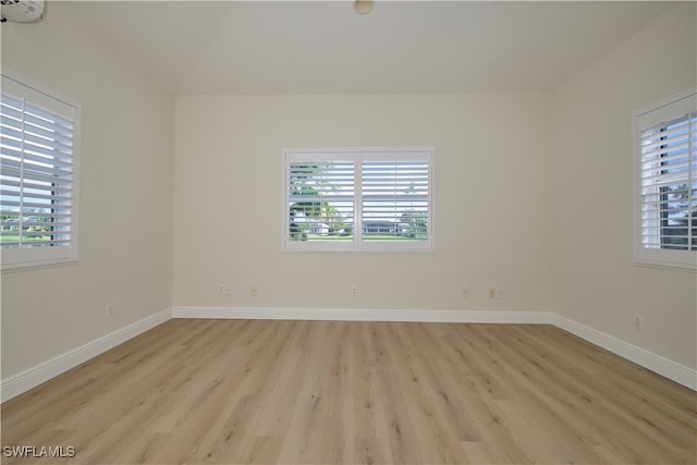 empty room featuring light hardwood / wood-style flooring and plenty of natural light