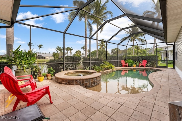 view of swimming pool with an in ground hot tub, a patio area, and a lanai