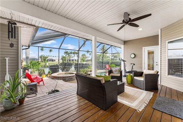 sunroom / solarium featuring a water view and ceiling fan