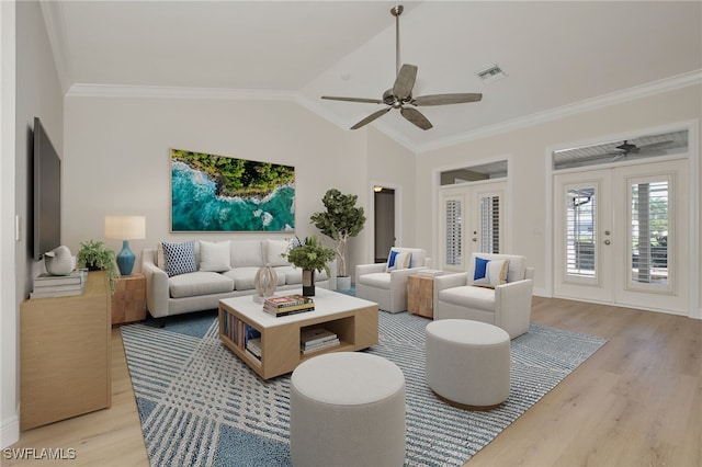 living room featuring ornamental molding, french doors, vaulted ceiling, and light hardwood / wood-style flooring