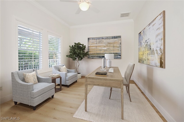 office space with crown molding, light wood-type flooring, and ceiling fan