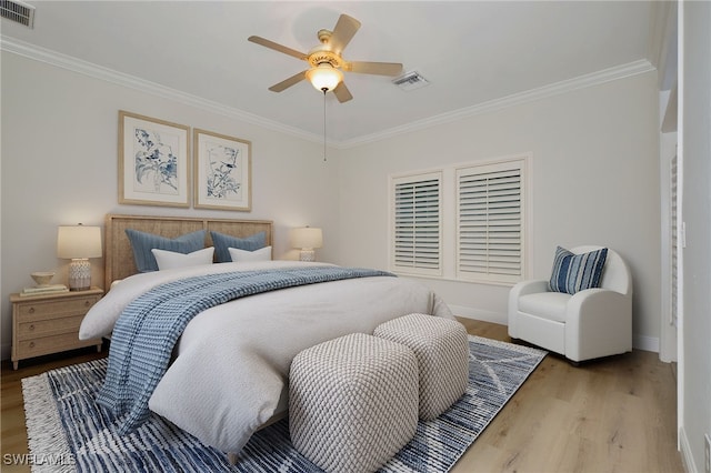 bedroom featuring ornamental molding, light wood-type flooring, and ceiling fan