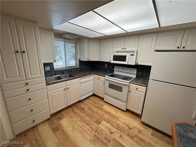 kitchen with light hardwood / wood-style floors, sink, white appliances, and white cabinetry