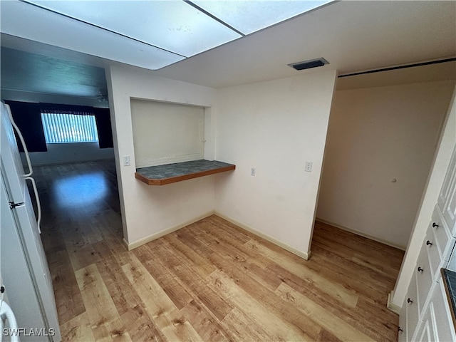 interior space featuring light hardwood / wood-style floors and white fridge