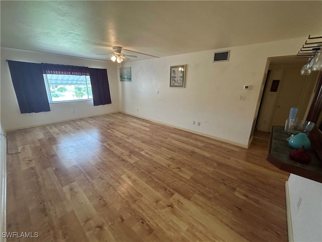 unfurnished room with wood-type flooring and ceiling fan