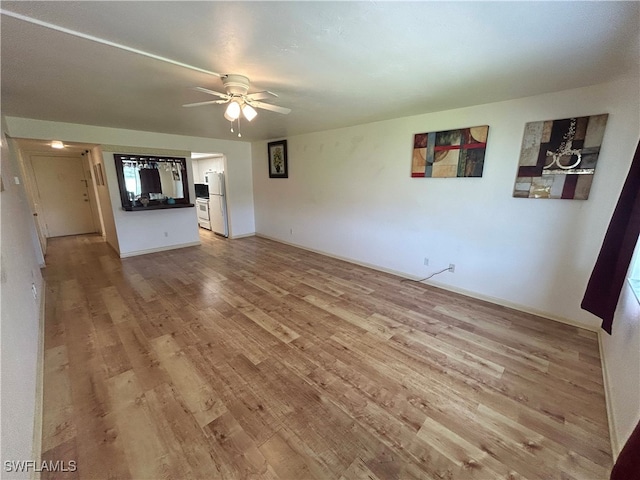 unfurnished living room featuring ceiling fan and light hardwood / wood-style floors