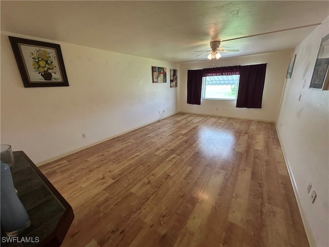 spare room with ceiling fan and light hardwood / wood-style flooring