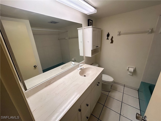 full bathroom with vanity, tile patterned flooring, toilet, and tiled shower / bath combo