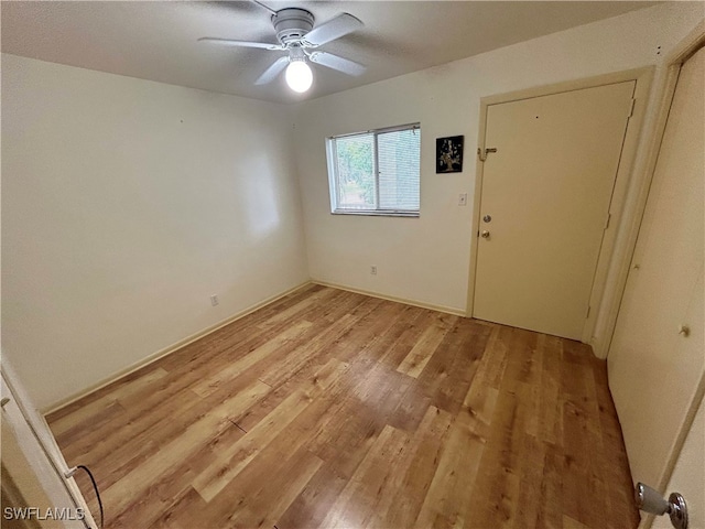 unfurnished room with ceiling fan and light hardwood / wood-style flooring