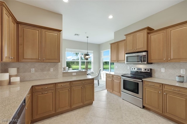 kitchen featuring pendant lighting, light tile patterned flooring, backsplash, appliances with stainless steel finishes, and light stone countertops