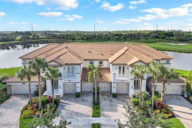 view of front of home featuring a garage and a water view