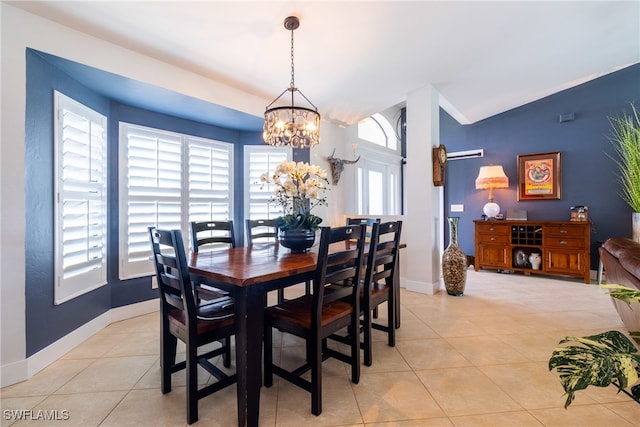 tiled dining space with vaulted ceiling and a notable chandelier