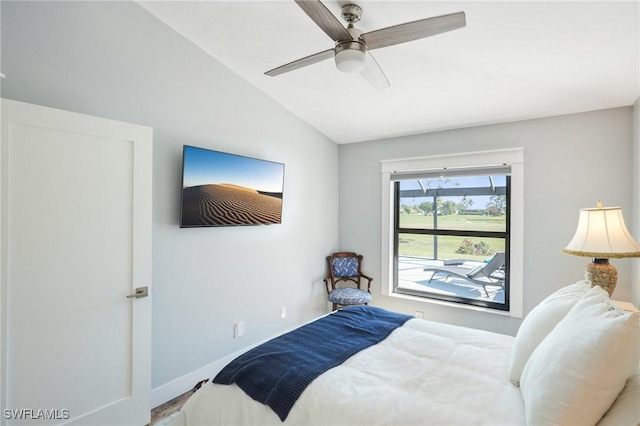 bedroom with lofted ceiling, baseboards, and a ceiling fan