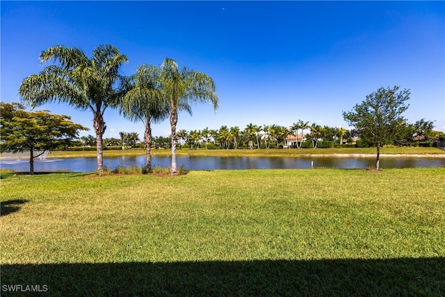 exterior space featuring a lawn and a water view