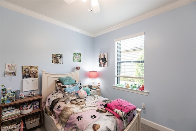 carpeted bedroom with ceiling fan and ornamental molding