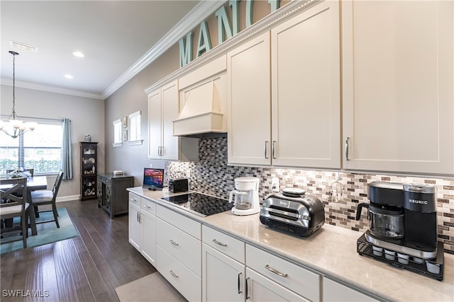 kitchen with premium range hood, white cabinetry, dark wood-type flooring, black electric stovetop, and a chandelier