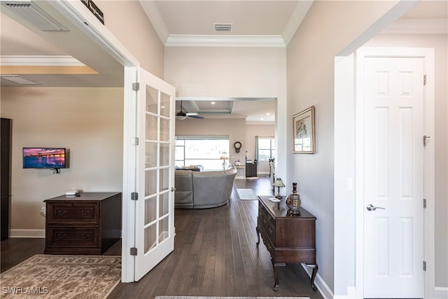 hallway featuring french doors, crown molding, and dark wood-type flooring