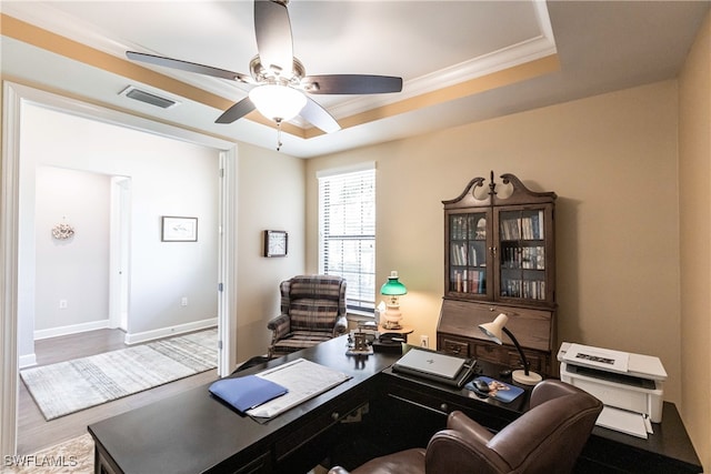 office area featuring ceiling fan, a raised ceiling, crown molding, and hardwood / wood-style floors