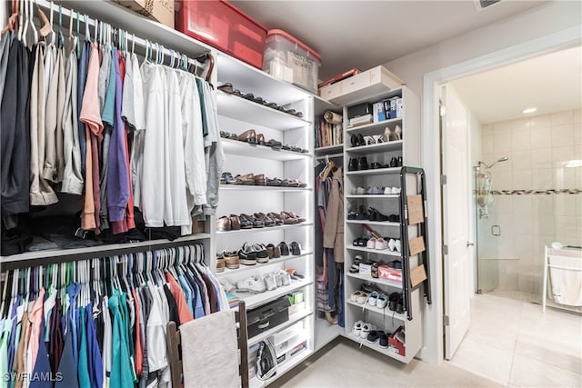 walk in closet with tile patterned floors