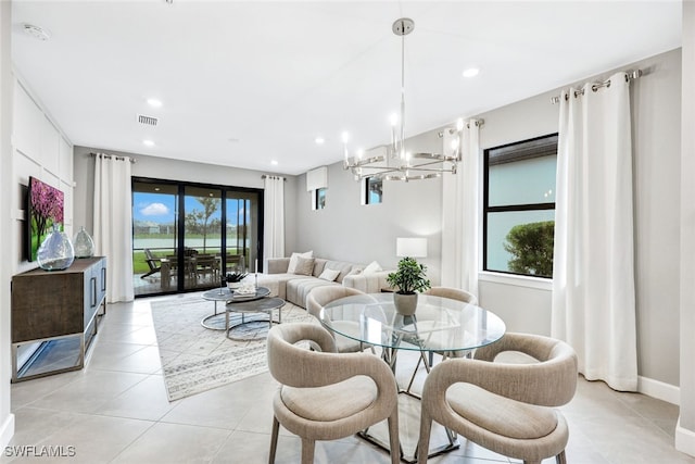 tiled dining space with a chandelier