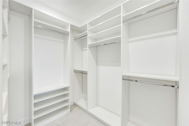 walk in closet featuring light tile patterned flooring