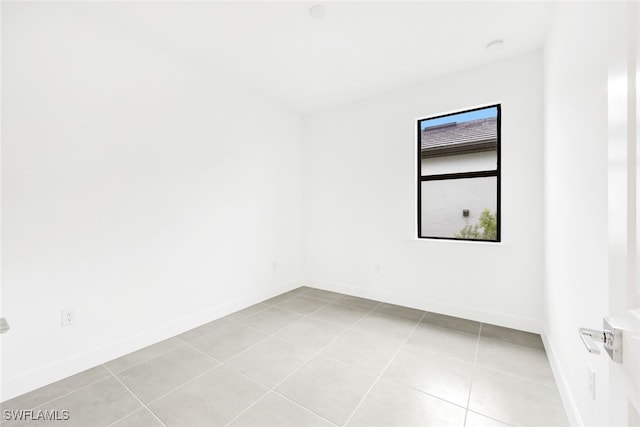 unfurnished room featuring light tile patterned floors