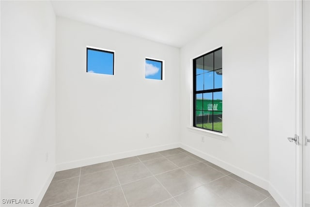 tiled empty room featuring a healthy amount of sunlight