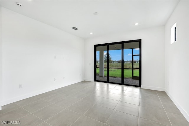 unfurnished room featuring light tile patterned floors