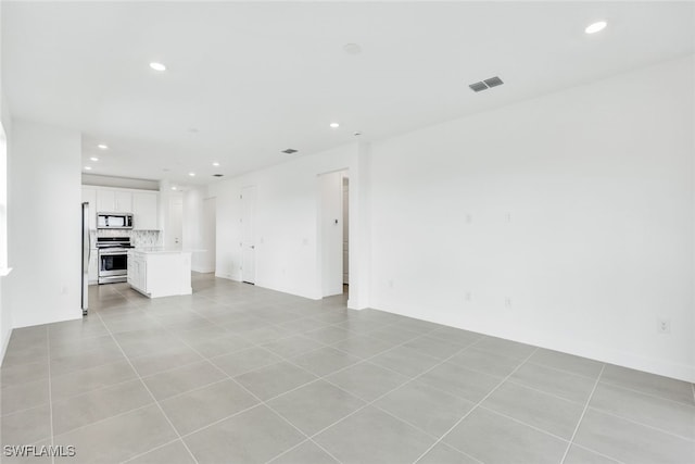 unfurnished living room with light tile patterned floors