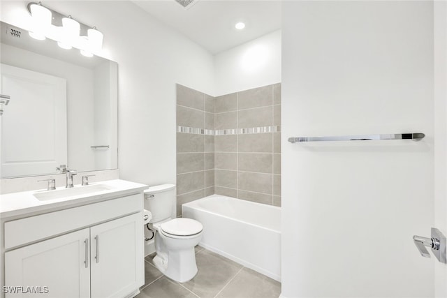 full bathroom featuring tiled shower / bath, vanity, toilet, and tile patterned floors