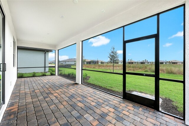 unfurnished sunroom featuring a wealth of natural light