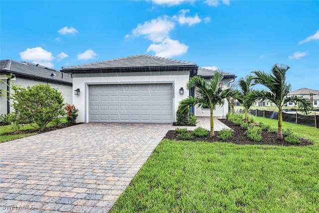 view of front of house with a front yard and a garage