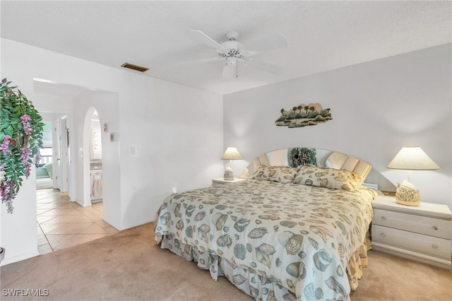 bedroom featuring ceiling fan and light carpet