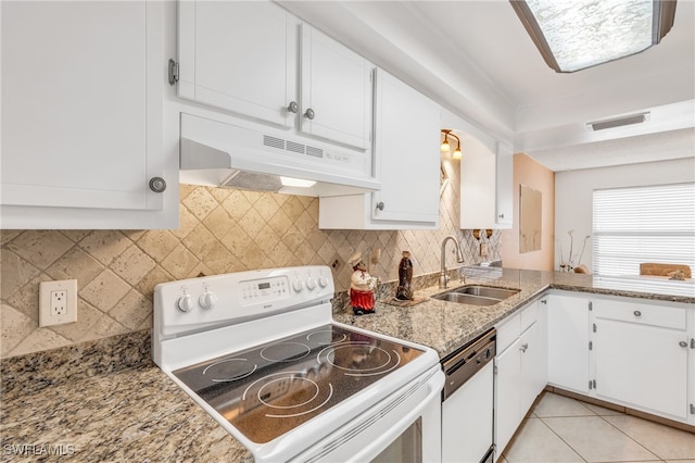 kitchen with white appliances, sink, light tile patterned floors, and white cabinets