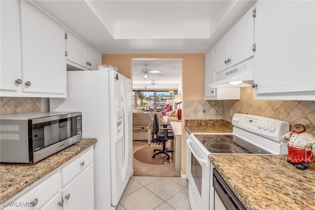 kitchen with light stone counters, light tile patterned flooring, white appliances, white cabinetry, and custom range hood