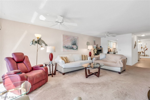 living room with light carpet and ceiling fan