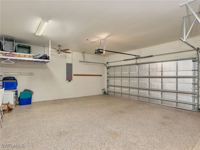 garage featuring electric panel, ceiling fan, and a garage door opener