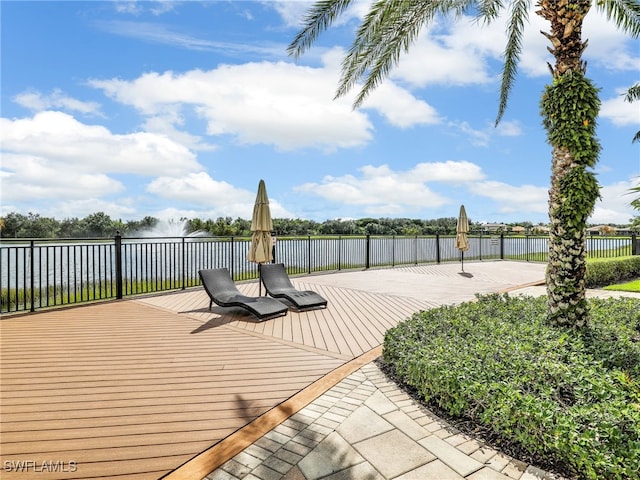 wooden terrace featuring a water view