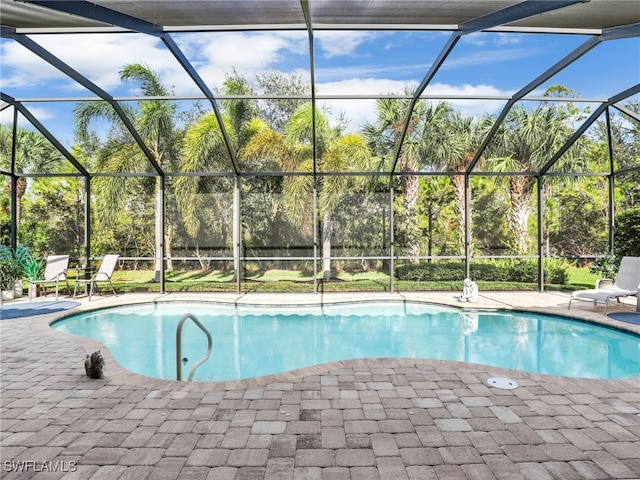 view of swimming pool with a patio and a lanai