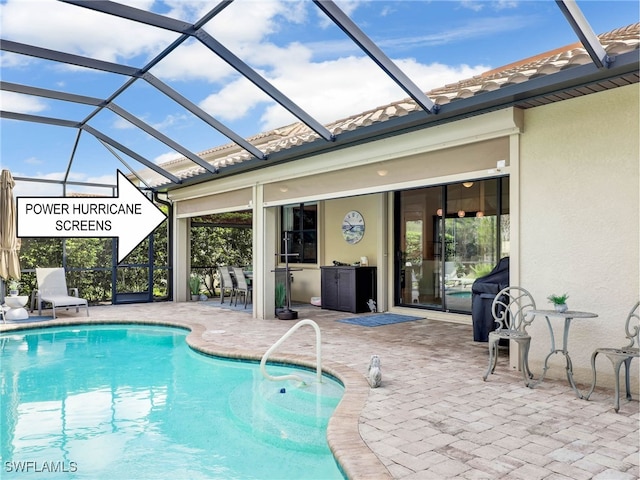 view of pool with a lanai and a patio