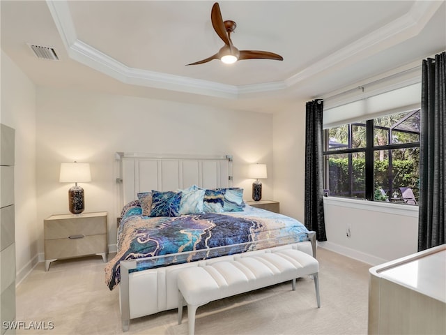 carpeted bedroom featuring ceiling fan, a raised ceiling, and ornamental molding