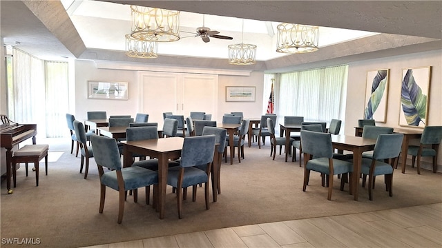 dining room featuring ceiling fan, light carpet, and a healthy amount of sunlight