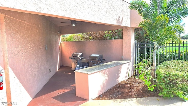 view of patio with ceiling fan and area for grilling