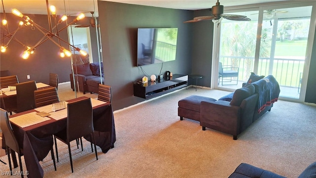 living room featuring ceiling fan with notable chandelier and light carpet