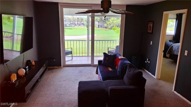 carpeted living room with ceiling fan