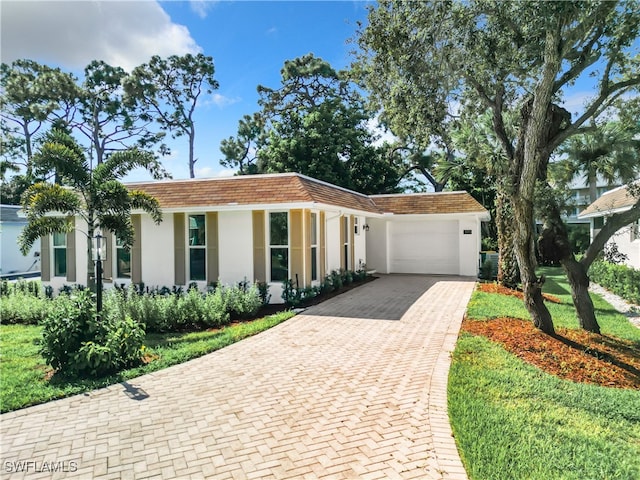 view of front of home featuring a garage and a front yard