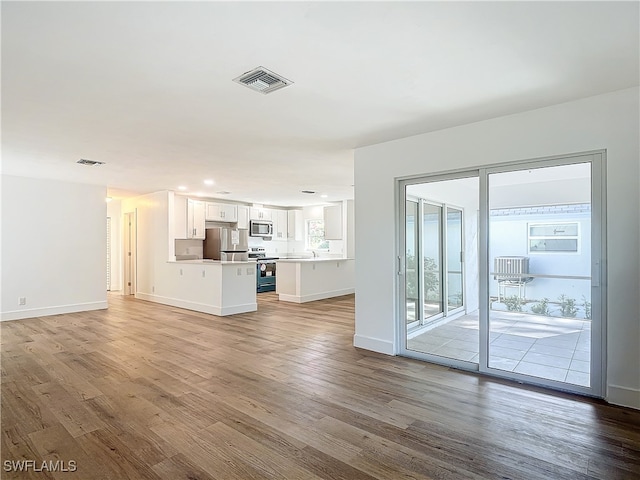 unfurnished living room featuring wood-type flooring